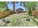 Spacious backyard featuring a fire pit, wood fence, and a charming deck with stairs leading to the home at 703 S Main St, Landis, NC 28088