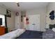 Bright bedroom featuring neutral walls, wood-look floors, and white closet doors at 703 S Main St, Landis, NC 28088