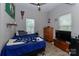 Bedroom features wood-look floors, neutral walls, and a ceiling fan at 703 S Main St, Landis, NC 28088