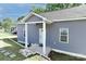 Quaint home featuring gray siding, a covered entrance, and a neatly landscaped yard at 703 S Main St, Landis, NC 28088