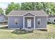 Cozy house with gray siding, a covered porch with white columns, and a well-maintained lawn at 703 S Main St, Landis, NC 28088