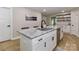Close up of a kitchen island, granite countertops, stainless steel dishwasher, and modern faucet at 703 S Main St, Landis, NC 28088