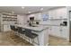 Bright kitchen boasts granite counters, a kitchen island with barstool seating, and modern white cabinetry at 703 S Main St, Landis, NC 28088
