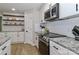 Well-appointed kitchen featuring stainless steel appliances, subway tile backsplash, and granite countertops at 703 S Main St, Landis, NC 28088