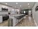 Modern kitchen boasts granite countertops, stainless steel appliances, and a large island with seating at 703 S Main St, Landis, NC 28088