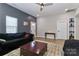Cozy living area includes modern furnishings, a ceiling fan, hardwood floors, and a contemporary gray accent wall at 703 S Main St, Landis, NC 28088