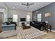 Comfortable living room with ceiling fan, contrasting wall colors, area rug and modern entertainment center at 703 S Main St, Landis, NC 28088