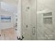 Bathroom featuring a glass shower with marble tile and built-in niche at 7768 Lynwood Ln, Sherrills Ford, NC 28673