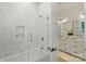 Modern bathroom featuring a tub with glass door and white subway tile at 7768 Lynwood Ln, Sherrills Ford, NC 28673