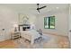 Bright bedroom with decorative rug, ceiling fan, and natural light from the backyard view at 7768 Lynwood Ln, Sherrills Ford, NC 28673