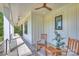 Serene covered porch with comfortable rocking chairs and a rustic ceiling fan for outdoor comfort at 7768 Lynwood Ln, Sherrills Ford, NC 28673