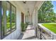 Charming covered porch with wood-paneled walls and elegant lighting, perfect for relaxing outdoors at 7768 Lynwood Ln, Sherrills Ford, NC 28673