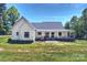 Inviting white farmhouse with covered porch and well-maintained grassy yard at 7768 Lynwood Ln, Sherrills Ford, NC 28673