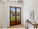 Bright foyer featuring elegant double doors, a jute rug, and a modern console table at 7768 Lynwood Ln, Sherrills Ford, NC 28673