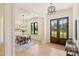 Open foyer with wood floors, stylish lighting, and views of the dining area and exterior through double doors at 7768 Lynwood Ln, Sherrills Ford, NC 28673