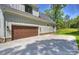 Home with a two car garage and spacious driveway surrounded by greenery at 7768 Lynwood Ln, Sherrills Ford, NC 28673