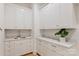Bright laundry room featuring white cabinetry, marble countertops, sink and modern fixtures at 7768 Lynwood Ln, Sherrills Ford, NC 28673
