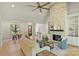 Inviting living room boasting a stone fireplace, built-in shelves, and open access to the dining area and front entrance at 7768 Lynwood Ln, Sherrills Ford, NC 28673