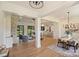 Open-concept living spaces featuring a living room with a stone fireplace, dining area, and kitchen at 7768 Lynwood Ln, Sherrills Ford, NC 28673