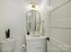 Modern powder room featuring a stylish gold mirror, white marble countertop and decorative faucet at 7768 Lynwood Ln, Sherrills Ford, NC 28673