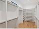 Walk-in closet with custom shelving and hardwood floors at 7768 Lynwood Ln, Sherrills Ford, NC 28673