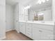 This bathroom features a double sink vanity, a modern mirror, updated fixtures, and a private toilet at 8901 Powder Works Dr, Huntersville, NC 28078