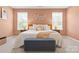 The primary bedroom offers soothing tones, windows, and a comfortable, inviting style at 8901 Powder Works Dr, Huntersville, NC 28078