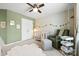 Comfortable Bedroom with soft rug, plush armchair, modern crib, and ample closet space at 8901 Powder Works Dr, Huntersville, NC 28078