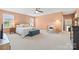 A spacious bedroom with a ceiling fan, sitting area and multiple windows for natural light at 8901 Powder Works Dr, Huntersville, NC 28078