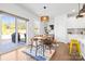 Dining area with sliding glass doors to patio, a pendant light, and a modern table at 8901 Powder Works Dr, Huntersville, NC 28078