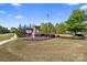 Inviting entrance to Arrington community with stone signage surrounded by vibrant landscaping at 8901 Powder Works Dr, Huntersville, NC 28078