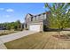 Beautifully landscaped front yard enhances the curb appeal of this inviting two-story home with a two-car garage at 8901 Powder Works Dr, Huntersville, NC 28078