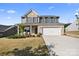Charming two-story home boasts brick and gray siding, a well-manicured lawn, and a convenient two-car garage at 8901 Powder Works Dr, Huntersville, NC 28078