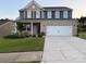 Beautiful two-story home with brick and siding, a well-manicured lawn, and an attached two-car garage at 8901 Powder Works Dr, Huntersville, NC 28078