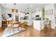 Modern kitchen boasts white cabinets, a dining area, stainless steel appliances, and ample counter space at 8901 Powder Works Dr, Huntersville, NC 28078