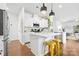 Bright kitchen featuring white cabinets, an island with seating, and modern pendant lighting at 8901 Powder Works Dr, Huntersville, NC 28078