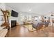 Cozy living room features hardwood floors, a fireplace, comfortable seating, and a bright, airy ambiance at 8901 Powder Works Dr, Huntersville, NC 28078
