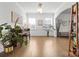 Spacious living room features hardwood floors, an arched doorway, and ample natural light for a welcoming atmosphere at 8901 Powder Works Dr, Huntersville, NC 28078
