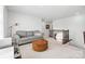Upstairs loft area with neutral carpet, a gray couch, and access to the upper level at 8901 Powder Works Dr, Huntersville, NC 28078