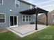 Stylish outdoor patio features a pergola, lush green lawn, and privacy fencing at 8901 Powder Works Dr, Huntersville, NC 28078