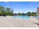 Large community pool with ample seating and shade umbrellas for relaxation at 8901 Powder Works Dr, Huntersville, NC 28078