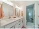 Bright bathroom with dual sinks, modern fixtures, and a glass-enclosed shower at 8902 Whittingham Dr, Waxhaw, NC 28173