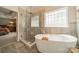 Spa-like bathroom with a freestanding tub and a glass-enclosed shower at 8902 Whittingham Dr, Waxhaw, NC 28173