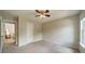 Neutral bedroom with a ceiling fan, closet, and large window at 8902 Whittingham Dr, Waxhaw, NC 28173