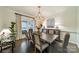 Elegant dining room with a large wooden table, chandelier, and decorative accents at 8902 Whittingham Dr, Waxhaw, NC 28173