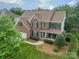 Traditional two-story brick home with manicured lawn and front porch, perfect for a growing Gathering at 8902 Whittingham Dr, Waxhaw, NC 28173