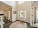 Bright foyer features a tall ceiling, a welcoming front door, and elegant rug at 8902 Whittingham Dr, Waxhaw, NC 28173