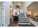 Elegant foyer with a staircase, dark hardwood floors, and stylish decor at 8902 Whittingham Dr, Waxhaw, NC 28173