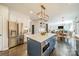 Modern kitchen with stainless steel appliances, white cabinets, island with marble countertops, and bar stool seating at 8902 Whittingham Dr, Waxhaw, NC 28173