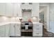 Close up of the kitchen with white cabinets, white countertops, stainless steel range and grey backsplash at 8902 Whittingham Dr, Waxhaw, NC 28173